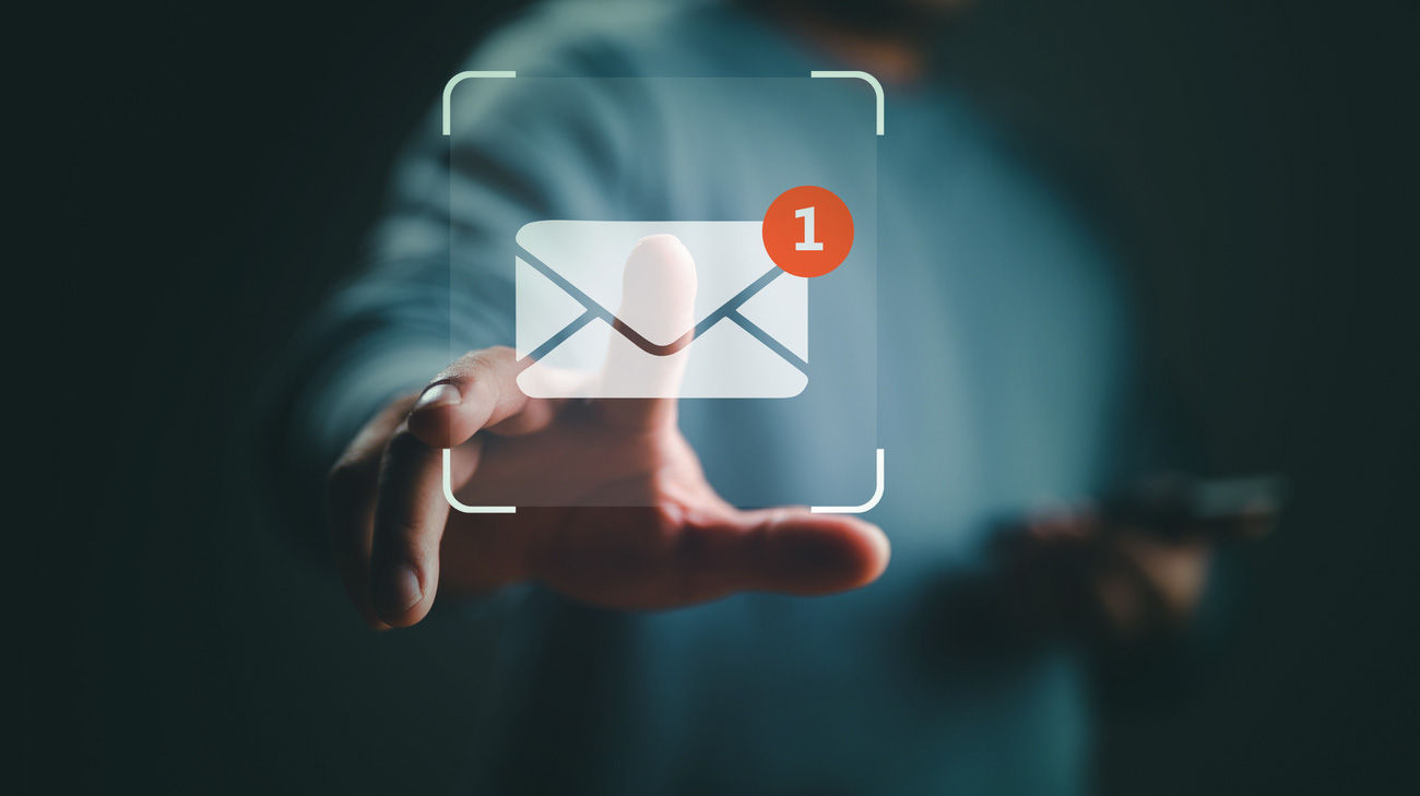 Hand reaching towards a digital email notification icon